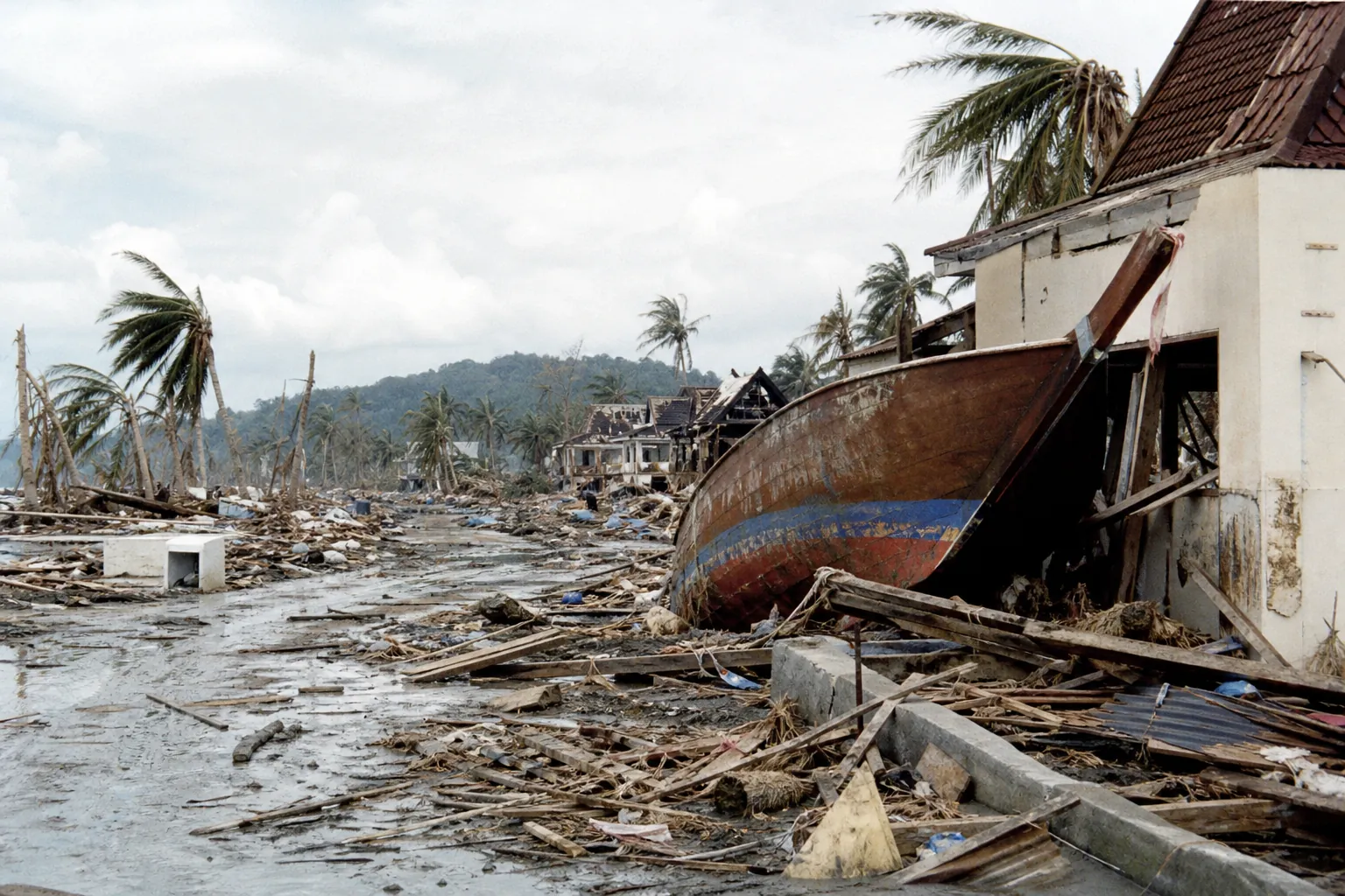 Khao Lak after the 2004 tsunami: a fishing boat thrown far inland